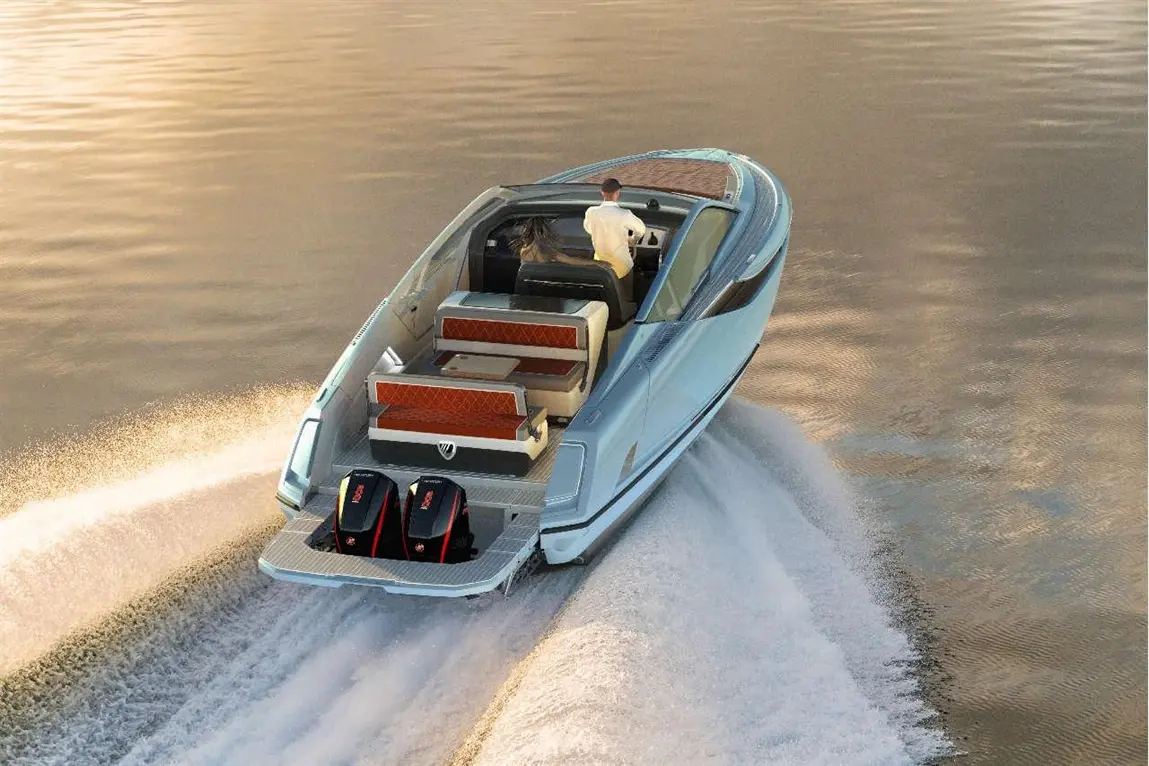 A sleek motorboat with a driver steers across shimmering water, leaving a wake behind, showcasing its powerful engines.